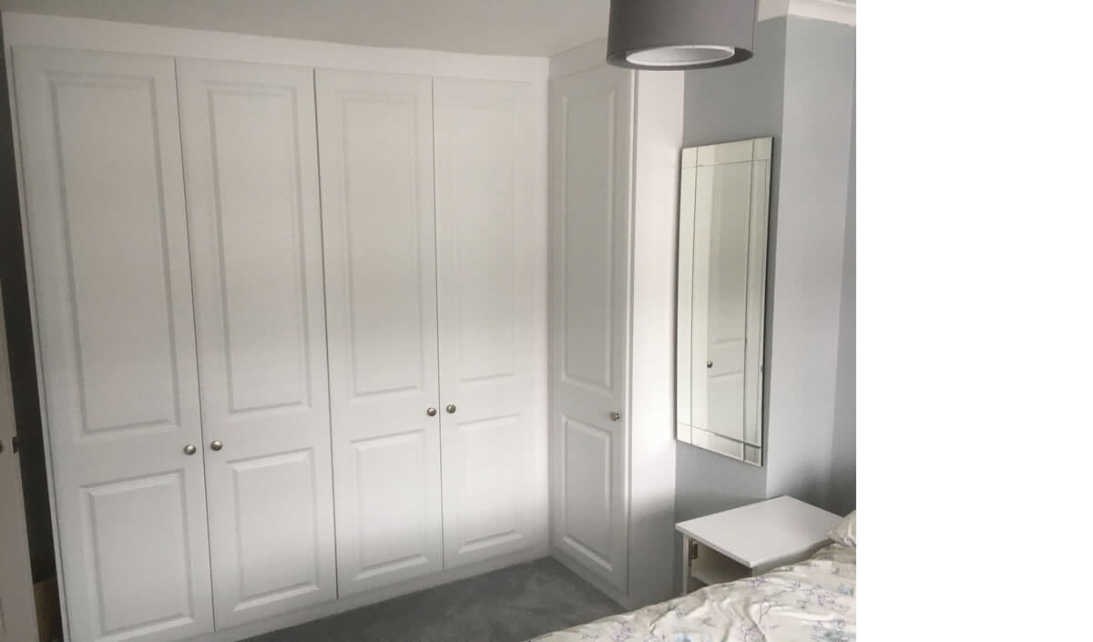 Corner wardrobe in Satin White with York style doors.