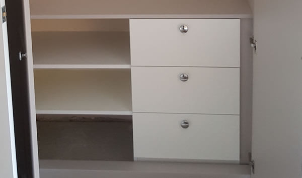 3 x drawers with 3 x shelves to the right and short hanging rail above.