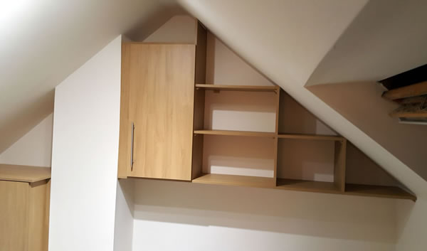 Bespoke short wardrobe, wall cupboard & shelves above bed