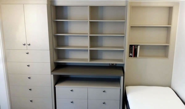 Wall unit, cupboard, pull-out desk with chest of drawers, shelves and bed.