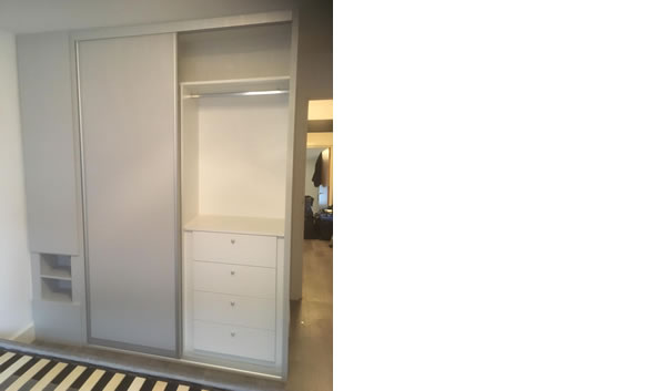 Sliding Wardrobe open showing chest of drawers and large shelf