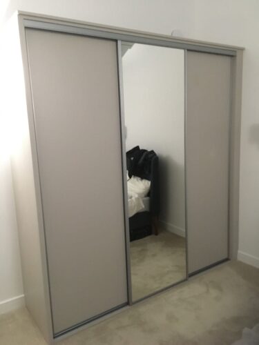 Sliding door wardrobe with centre mirror door