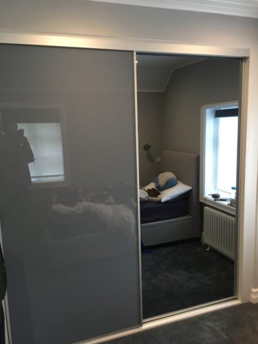 Sliding wardrobe with high gloss and mirror doors.