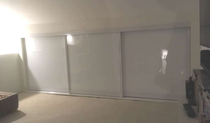 Three double wardrobes in Platinum White with Aluminium and White Colour Glass doors in the Attic.