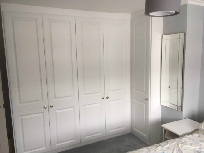 Corner wardrobe in Satin White with York style doors.