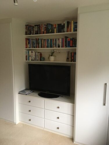 Two double hinged door wardrobes with matching chest of drawers, TV unit and shelves.