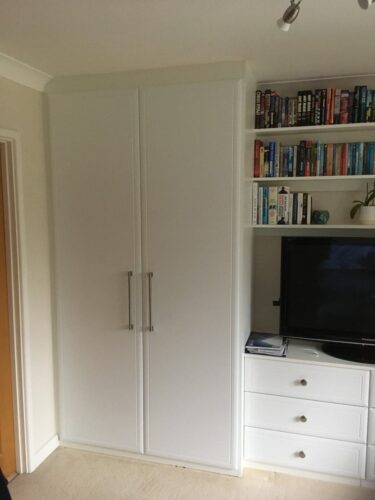 Two double hinged door wardrobes with matching chest of drawers, TV unit and shelves.