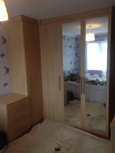 Light Ferrara Oak - Venice Style Doors Bespoke corner wardrobe with some mirror doors, drawer chest & shelf unit.