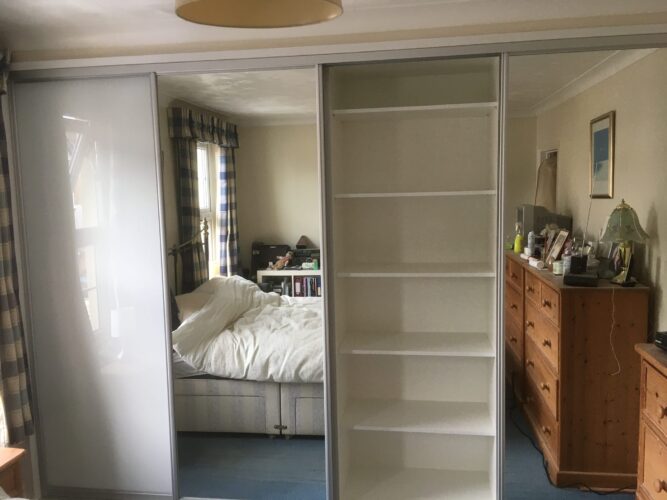 Shelves. Four Sliding Door Double Wardrobes in Alpine White with 2 Pure White glass & 2 Mirror Aluminium doors.