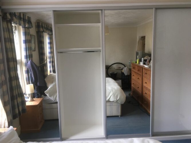 Shelves & Hanging Space. Four Sliding Door Double Wardrobes in Alpine White with 2 Pure White glass & 2 Mirror Aluminium doors.