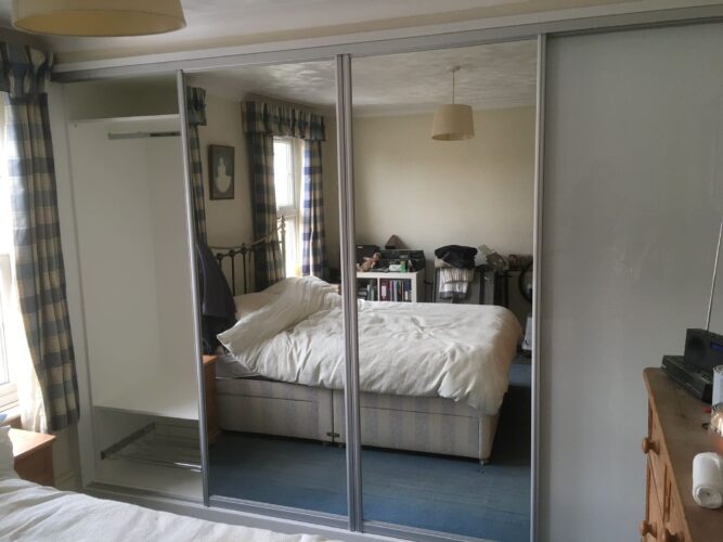 Shelves, Hanging Space and Shoe Rack. Four Sliding Door Double Wardrobes in Alpine White with 2 Pure White glass & 2 Mirror Aluminium doors.