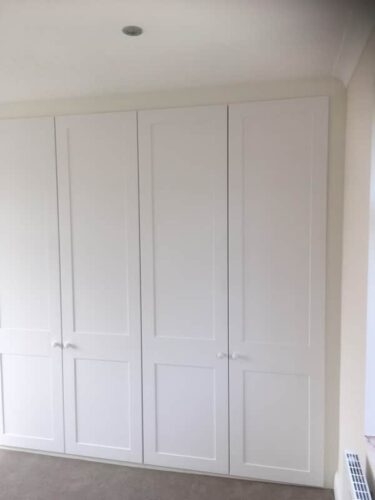 Three double hinged door fitted wardrobes.