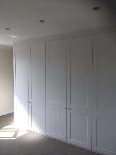 Three double hinged door fitted wardrobes.