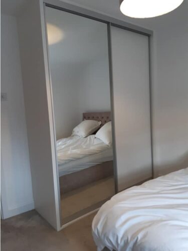 Sliding wardrobe with mirror door.