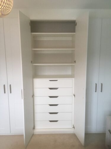 Shelves with chest of drawers.