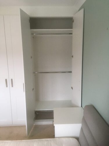 Shelves with chest of drawers.