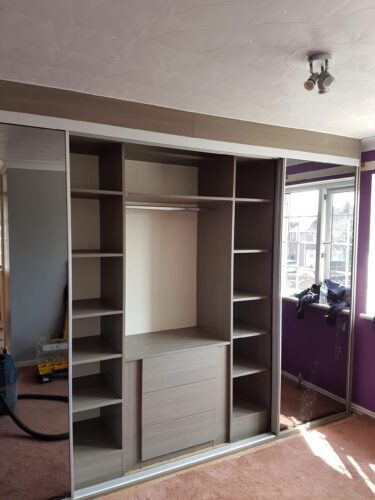 Interior shelving, hanging space and chest of drawers.