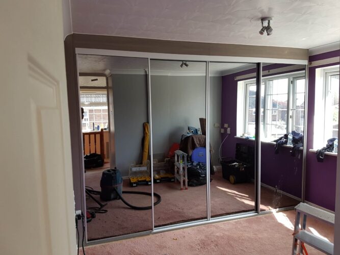 Four mirror door sliding wardrobe.