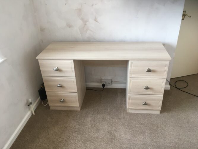 Dressing table matching fitted wardrobe and headboard.