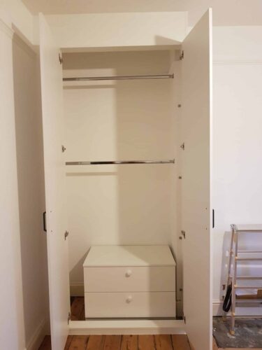 Hanging space with chest of drawers.