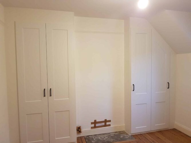 Hinged Wardrobe and Angled hinged wardrobe either side of a chimney breast.