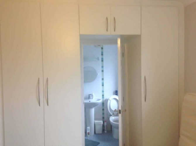 Platinum White - Venice Style. Wardrobes around the en suite door