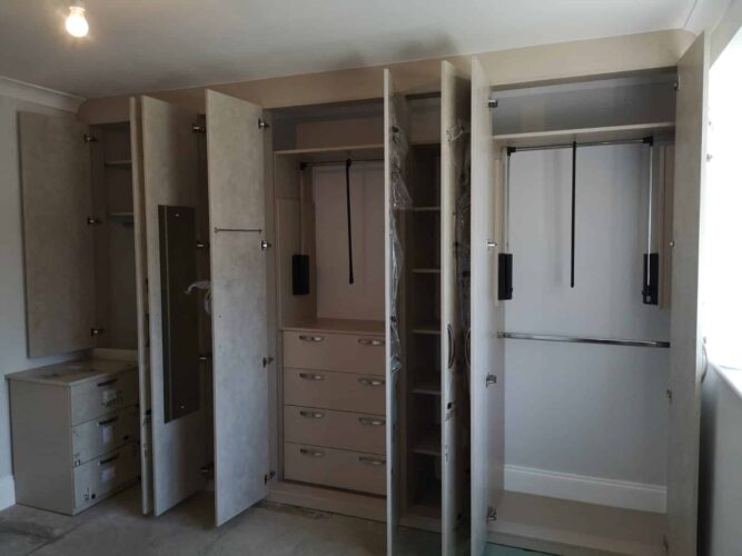 Ultragloss Limestone Wardrobe. 3 doubles & 2 singles robes with 2 pull down hanging rails, chest of drawers and shelving.