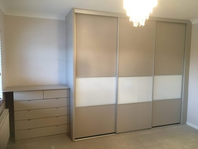 Triple sliding door wardrobe with matching chest of drawers.