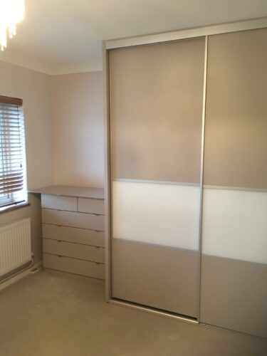 Triple sliding door wardrobe with matching chest of drawers.