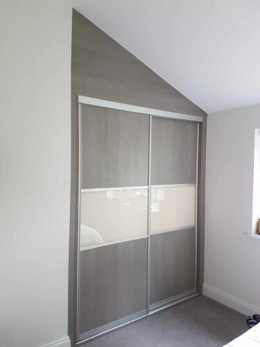 Sliding wardrobe with a sloping ceiling.